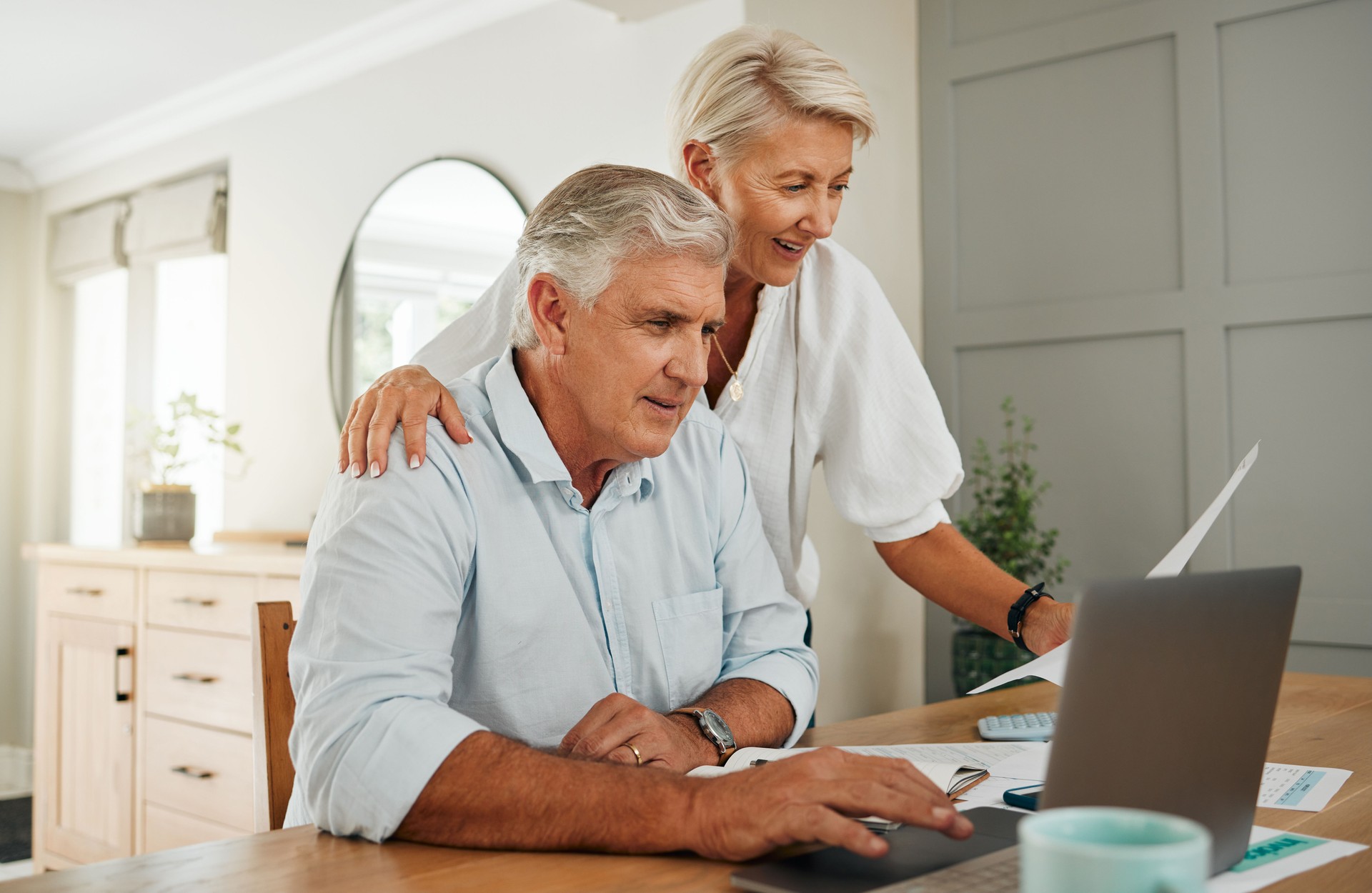 Senior couple with laptop for life insurance documents, home retirement planning or investment with online ecommerce website or banking. Elderly people with tax paperwork, pension or asset management